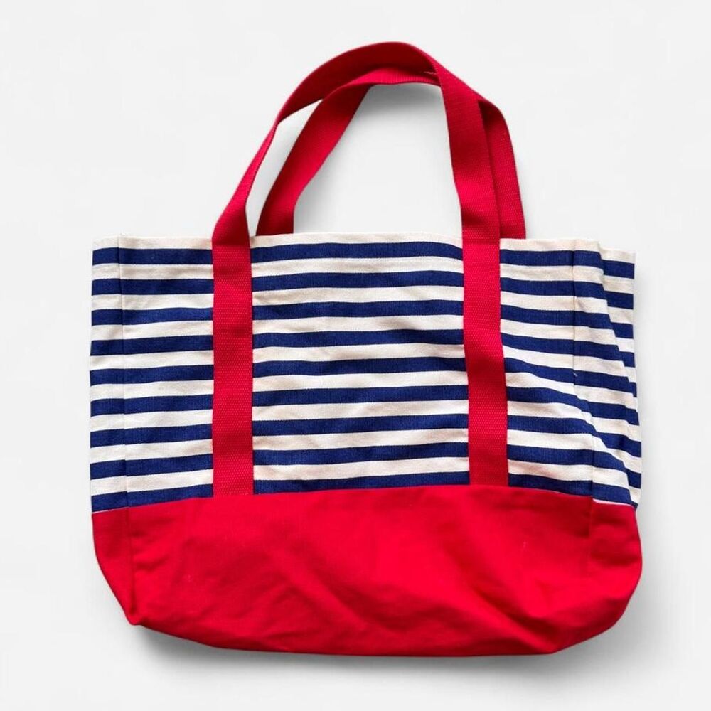 white and blue striped tote bag with red bottom and handles